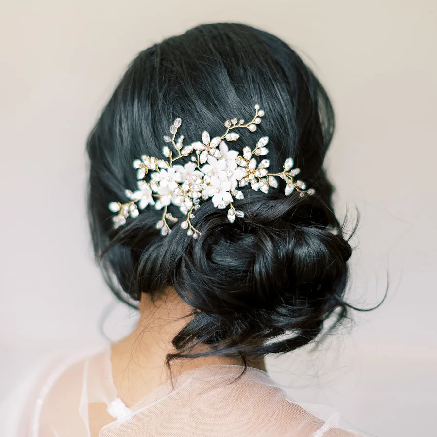 Image of bride looking away from the camera with a floral comb in her hair